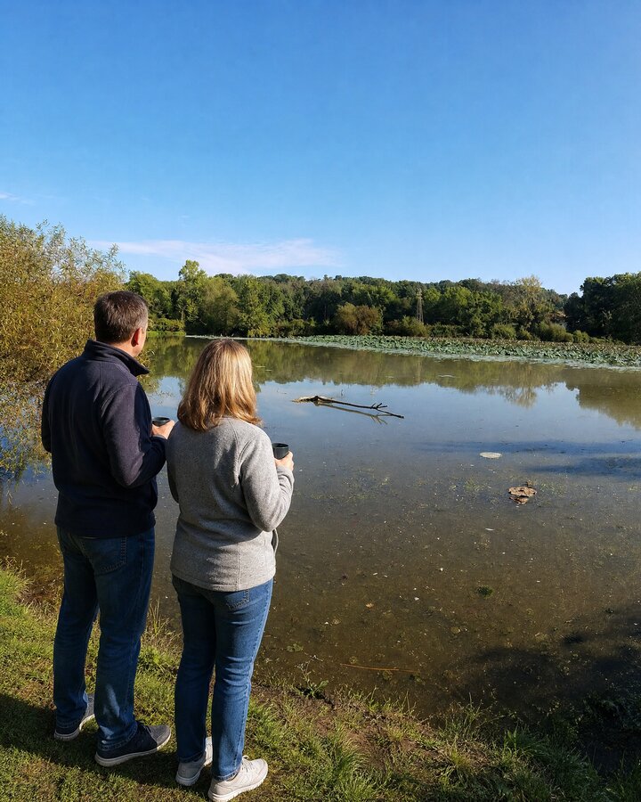 A couple with coffee on the Lake Logan shore